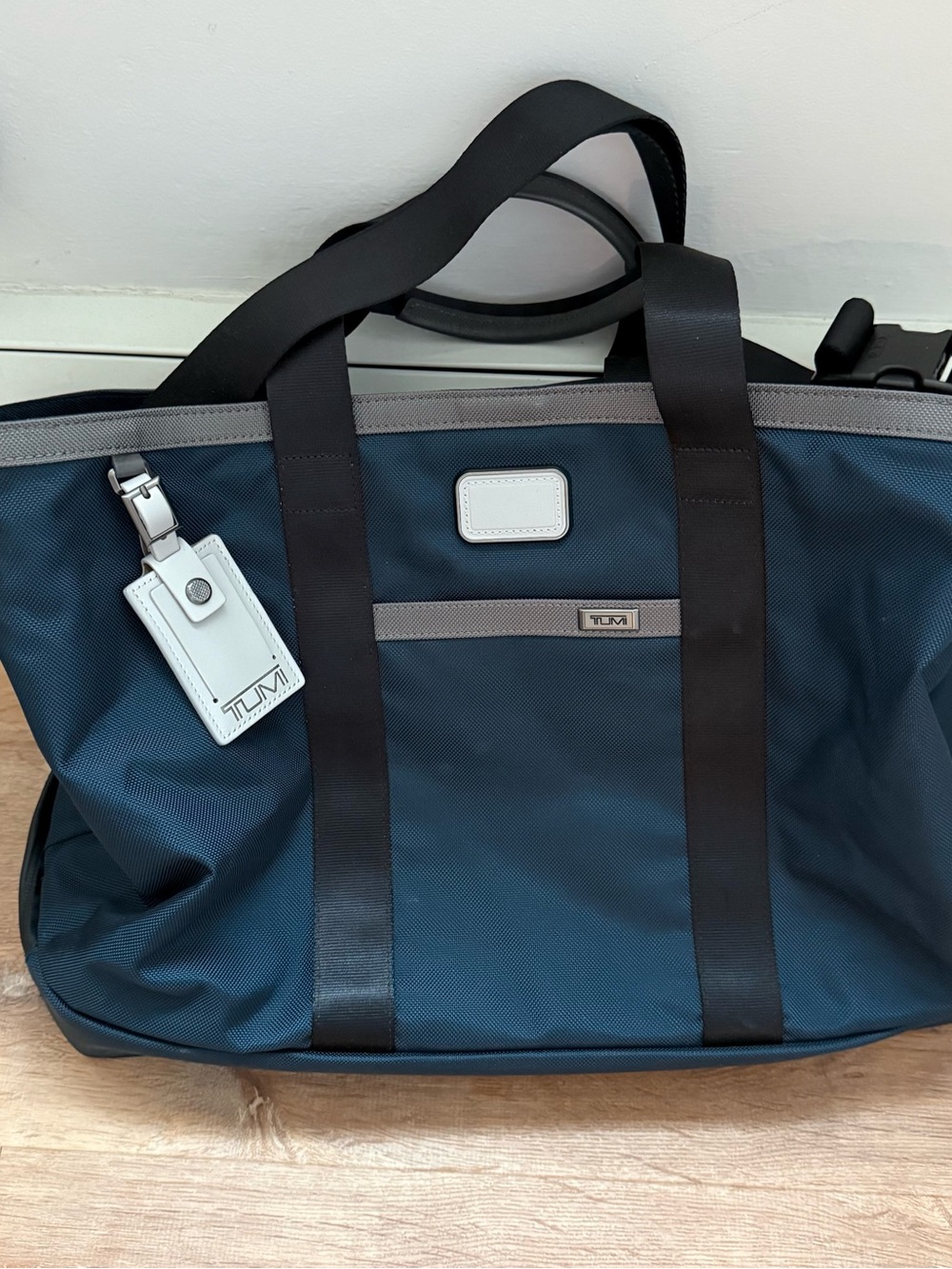 Tumi Navy Duffel Bag with Black Straps and Gray Trim